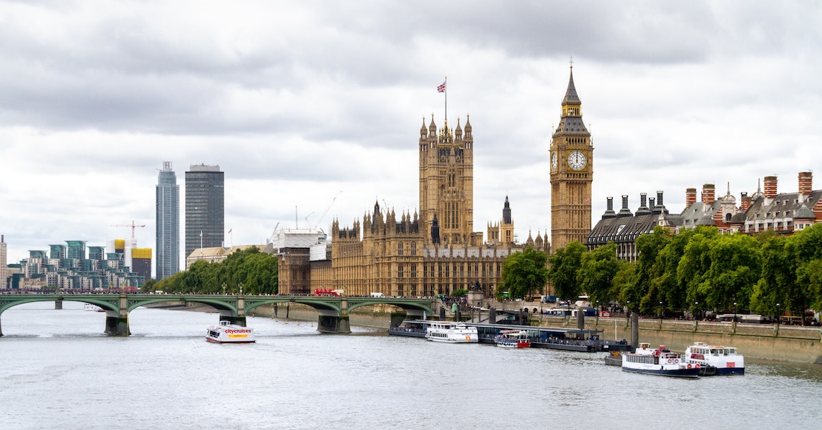 Beige stone buildings of the Palace of Westminster along the River Thames in London, United Kingdom, one of the best vacations for retirees