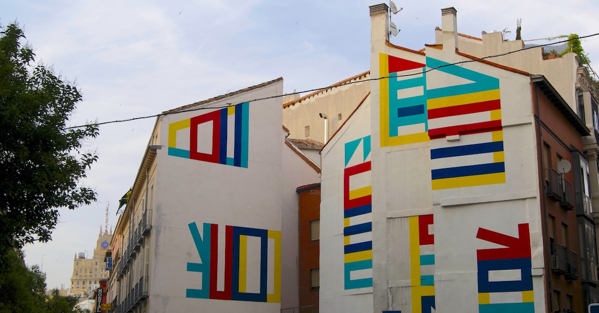 Colorful lines painted on the side of a building in Las Letras, Madrid