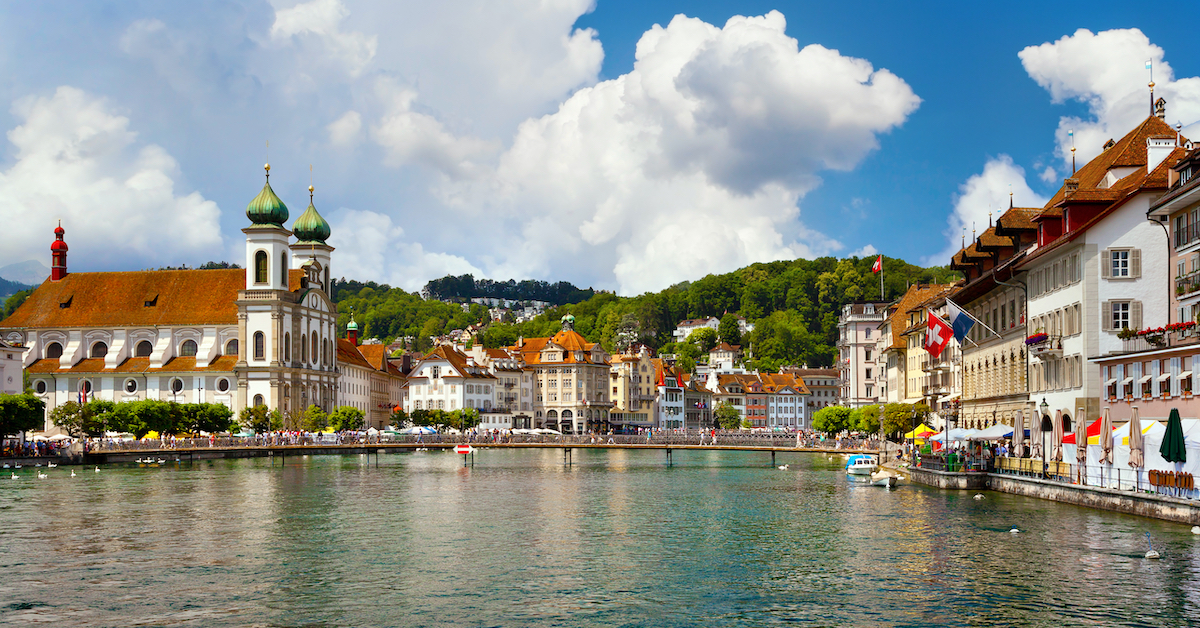 Bridge spanning a river in Lucerne, Switzerland with medieval buildings lining both sides