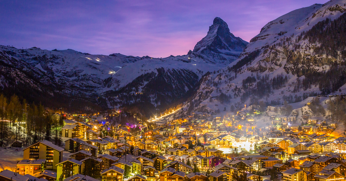 Aerial view of Zermatt, Switzerland with at sunset with the Matterhorn and surrounding snowy mountains rising out of the background