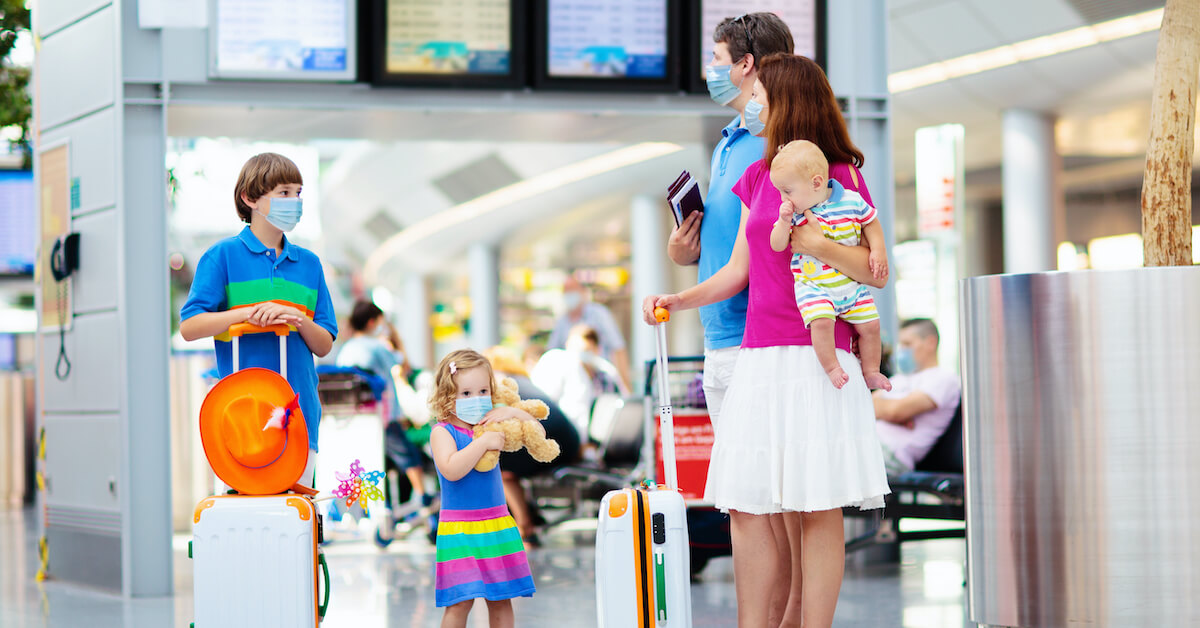 Family with young children in an airport wearing masks