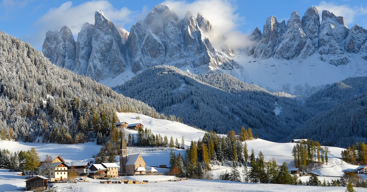 The village of Santa Maddalena, Italy and the Dolomites mountain range in the background covered in snow