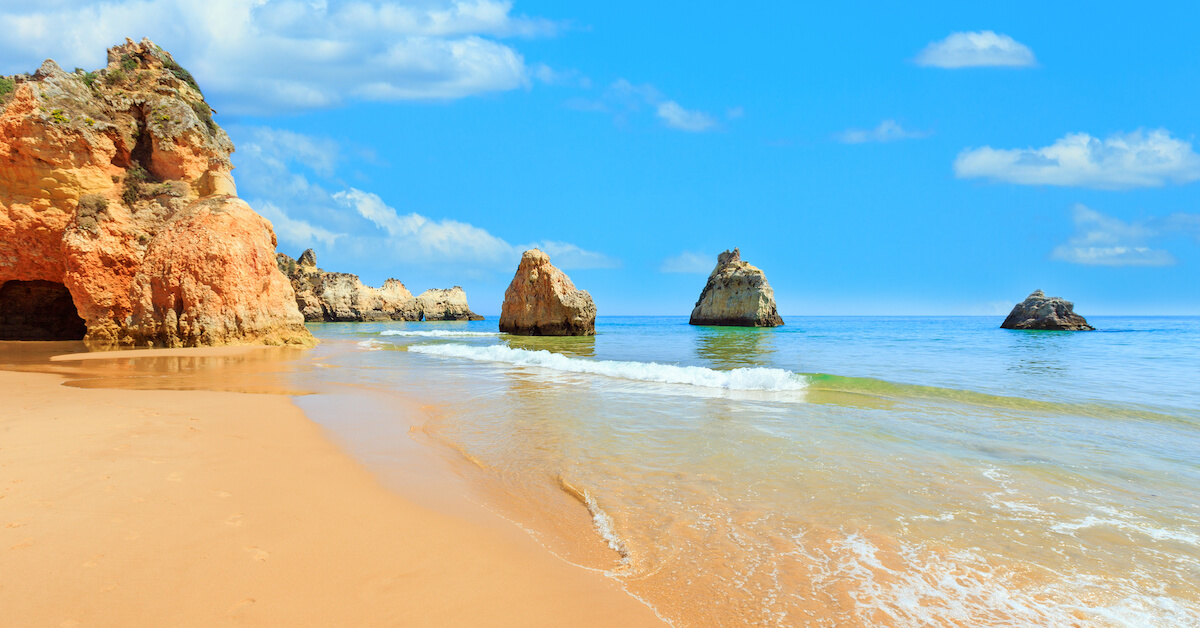 Golden sandy coastline on a sunny day in the Algarve, Portugal