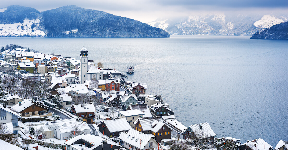 Aerial view of a snow-covered city on Lake Lucerne with mountains in the distance in Switzerland