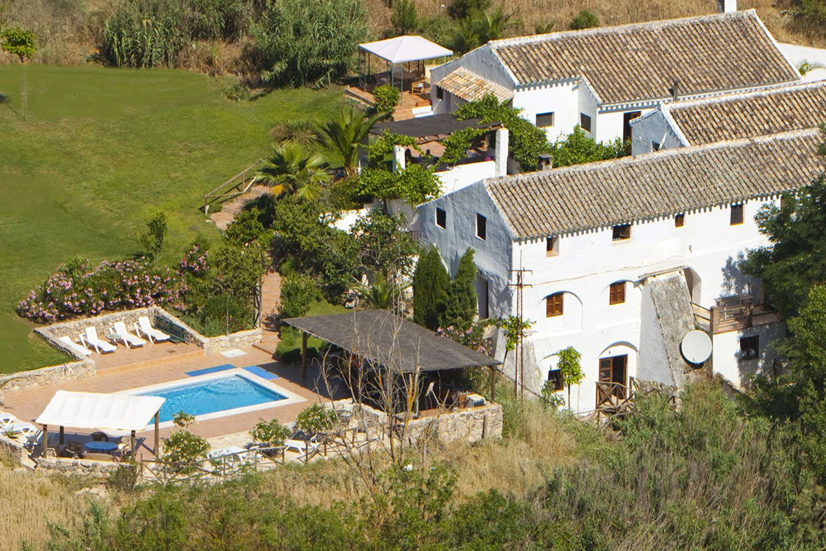<b>El Molino del Conde, Malaga</b> - Located near the lovely Lake Iznajar, El Molino del Conde is a grand Andalucian mill house-turned holiday rental. Secluded by large gardens and surrounded by hills and olive groves, this charming white estate features a pool and multiple terraces where you can eat a leisurely dinner with family.