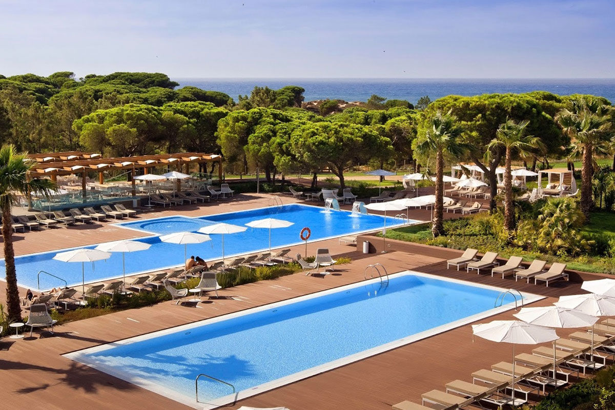 <b>Epic Sana Algarve, Albufeira</b> - Wander 7 minutes down to Praia da Falesia beach in the morning, play some tennis in the afternoon, cool off at one of 3 outdoor pools in the evening, and spend the night sipping cocktails while watching the live entertainment perform. This is a typical day at Epic Sana Algarve, where guests appreciate the ultra-modern exteriors and upscale interiors.