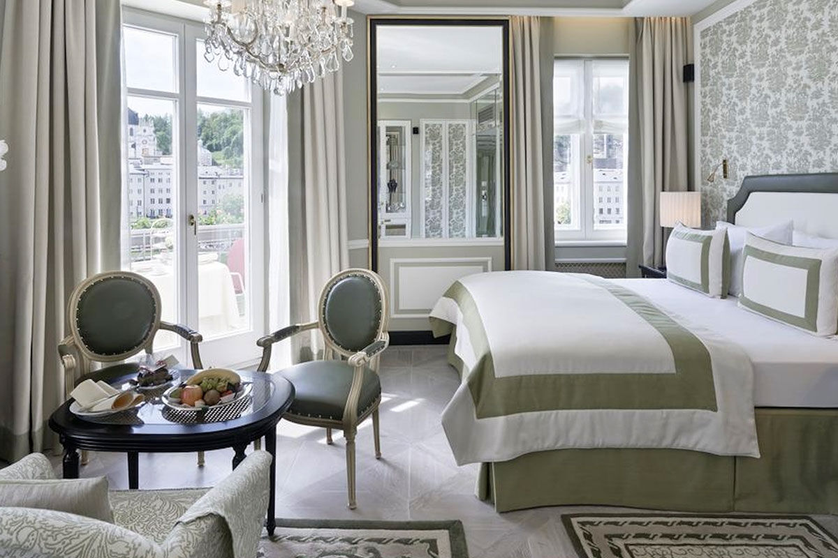 <b>Hotel Sacher</b> - Est. 1866 on the banks of the Salzach River, Hotel Sacher is a 5-minute walk to Salzburg’s old town and Schloss Mirabell Palace as well as a 10-minute walk to the Salzburger Dom Cathedral. Guests can dine at one of 3 restaurants, each with a different atmosphere and cuisine; the café, cocktail bar and chocolate shop tempt guests with their offerings; the plush rooms are designed with tradition in mind, featuring antiques and oil paintings throughout.