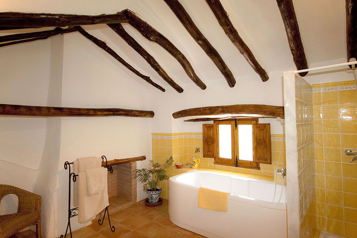 <b>El Molino del Conde, Malaga</b> - Located near the lovely Lake Iznajar, El Molino del Conde is a grand Andalucian mill house-turned holiday rental. Secluded by large gardens and surrounded by hills and olive groves, this charming white estate features a pool and multiple terraces where you can eat a leisurely dinner with family.