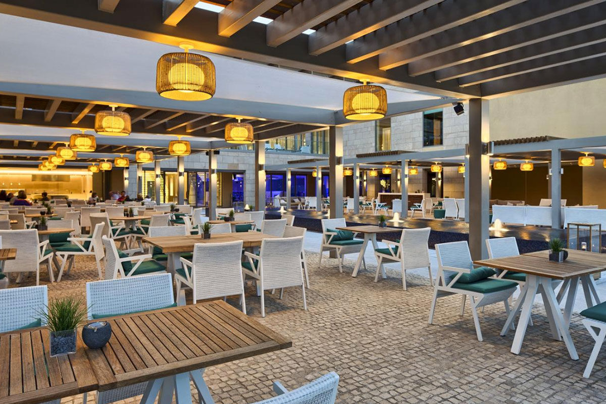 <b>Epic Sana Algarve, Albufeira</b> - Wander 7 minutes down to Praia da Falesia beach in the morning, play some tennis in the afternoon, cool off at one of 3 outdoor pools in the evening, and spend the night sipping cocktails while watching the live entertainment perform. This is a typical day at Epic Sana Algarve, where guests appreciate the ultra-modern exteriors and upscale interiors.