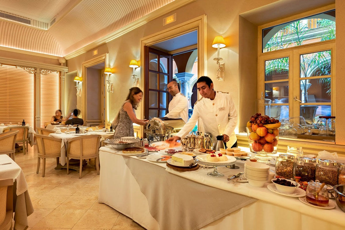 <b>Boutique Hotel Casa del Poeta</b> - With a warm orange courtyard, full of lush greenery, this historic mansion is a 3-minute walk to the Seville Cathedral and a 7-minute walk to the Alcazar of Seville. Rooms are classically elegant and the fountain in the center of the courtyard is guests’ favorite detail.