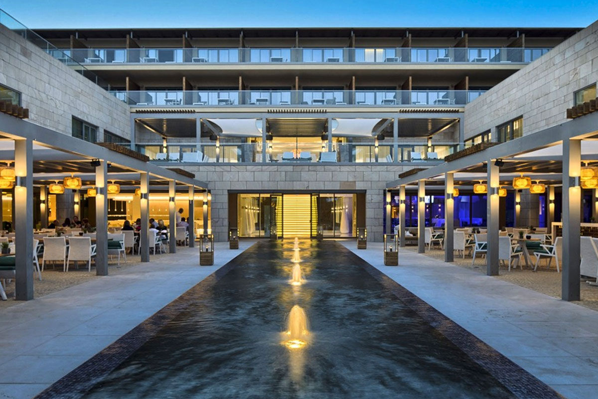 <b>Epic Sana Algarve, Albufeira</b> - Wander 7 minutes down to Praia da Falesia beach in the morning, play some tennis in the afternoon, cool off at one of 3 outdoor pools in the evening, and spend the night sipping cocktails while watching the live entertainment perform. This is a typical day at Epic Sana Algarve, where guests appreciate the ultra-modern exteriors and upscale interiors.