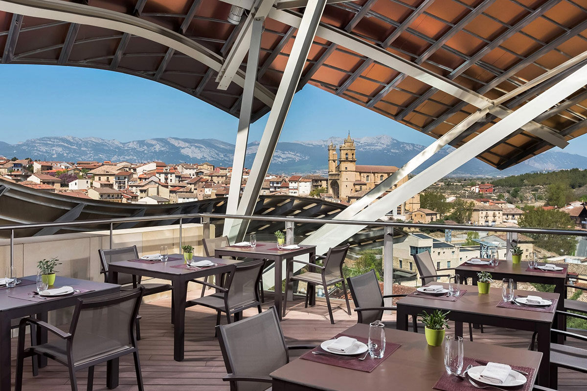 <b>Hotel Marques de Riscal, Elciego</b> - Designed by architect Frank Gehry, the Hotel Marques de Riscal is a piece of artwork in and of itself and has incredible views over the vineyard. Nestled within the medieval village of Elciego, the spectacular curves, titanium roof and avant garde feel is surprising within the region, to say the least!