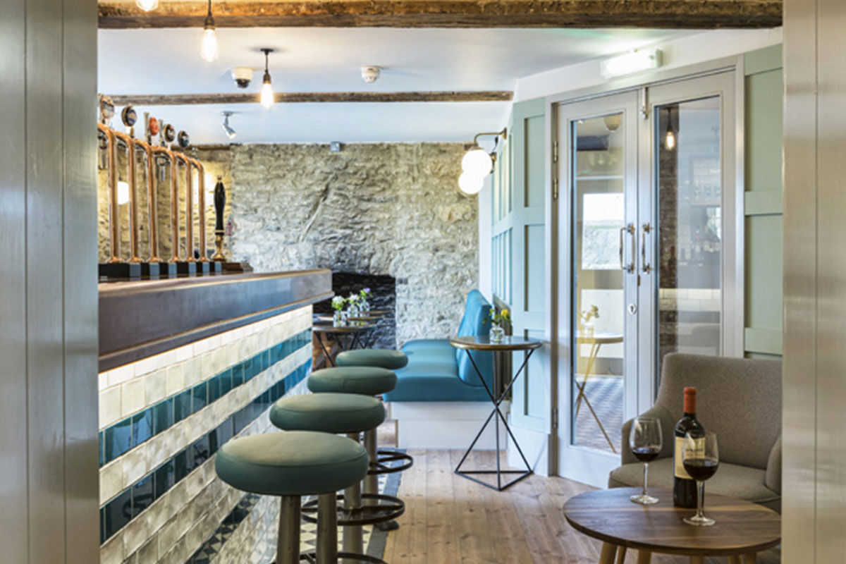 <b>The Old Stocks Inn, Stow-on-the-Wold</b> - This 17th century coaching inn set in Stow-on-the-Wold’s historic market square has been refurbished into a boutique hotel with character and charisma. There’s a historic pub with exposed oak beams and a log fireplace along with an English patio garden and vibrant detailing.