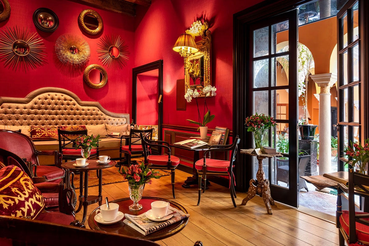 <b>Boutique Hotel Casa del Poeta</b> - With a warm orange courtyard, full of lush greenery, this historic mansion is a 3-minute walk to the Seville Cathedral and a 7-minute walk to the Alcazar of Seville. Rooms are classically elegant and the fountain in the center of the courtyard is guests’ favorite detail.