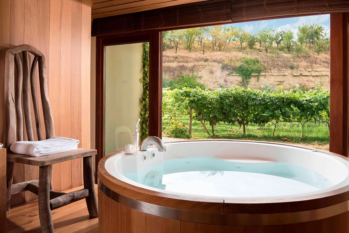 <b>Hotel Marques de Riscal, Elciego</b> - Designed by architect Frank Gehry, the Hotel Marques de Riscal is a piece of artwork in and of itself and has incredible views over the vineyard. Nestled within the medieval village of Elciego, the spectacular curves, titanium roof and avant garde feel is surprising within the region, to say the least!