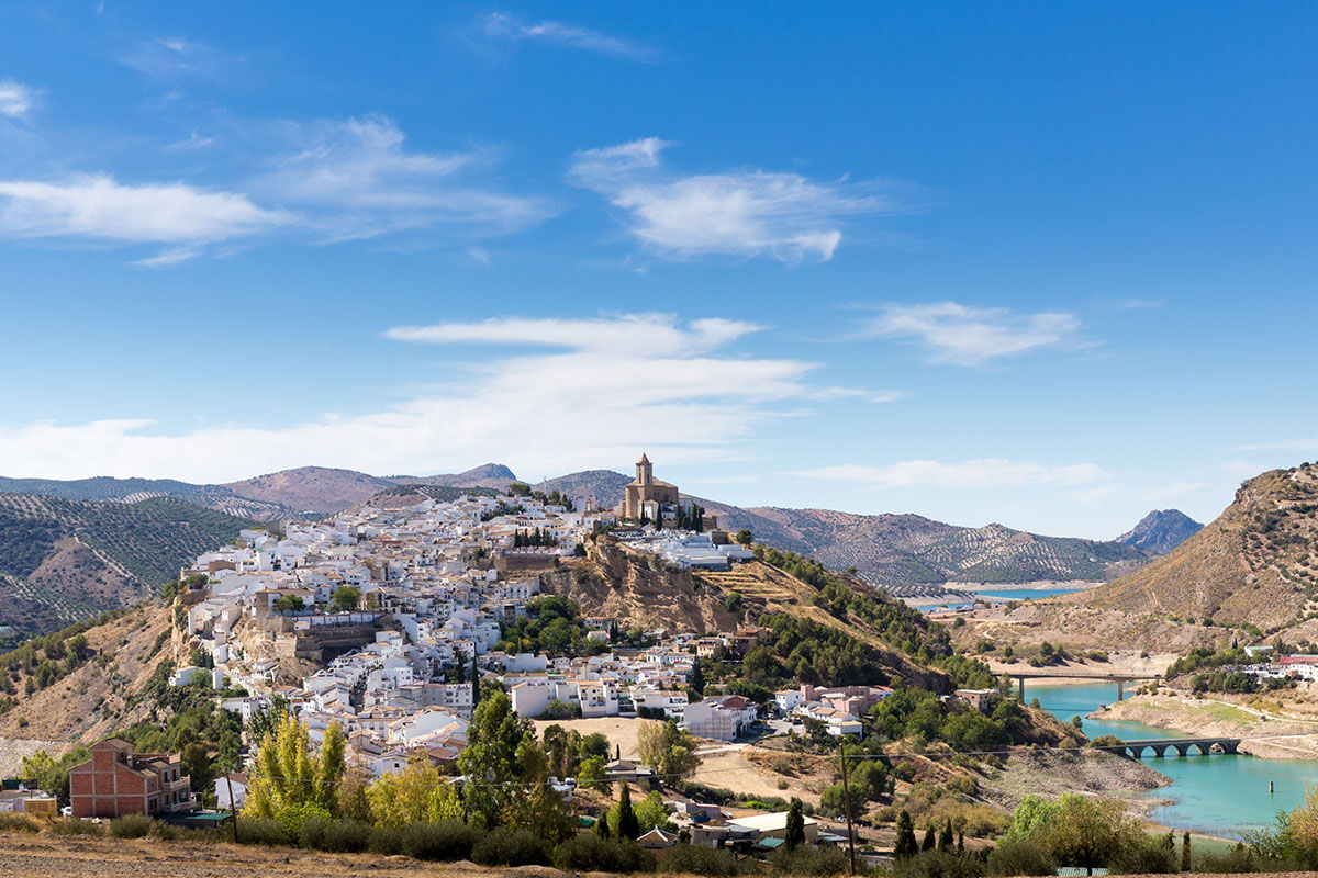<b>El Molino del Conde, Malaga</b> - Located near the lovely Lake Iznajar, El Molino del Conde is a grand Andalucian mill house-turned holiday rental. Secluded by large gardens and surrounded by hills and olive groves, this charming white estate features a pool and multiple terraces where you can eat a leisurely dinner with family.