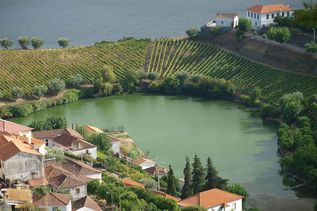 <b>Casa de Sao Domingos, Peso da Regua</b> - This quaint B&B gets its charm from the plants growing in terracotta pots, its stone wall next to the pool, and the sun loungers with parasols. The views of the Duoro River with hills in the background makes for a perfect backdrop for your relaxing vacation.