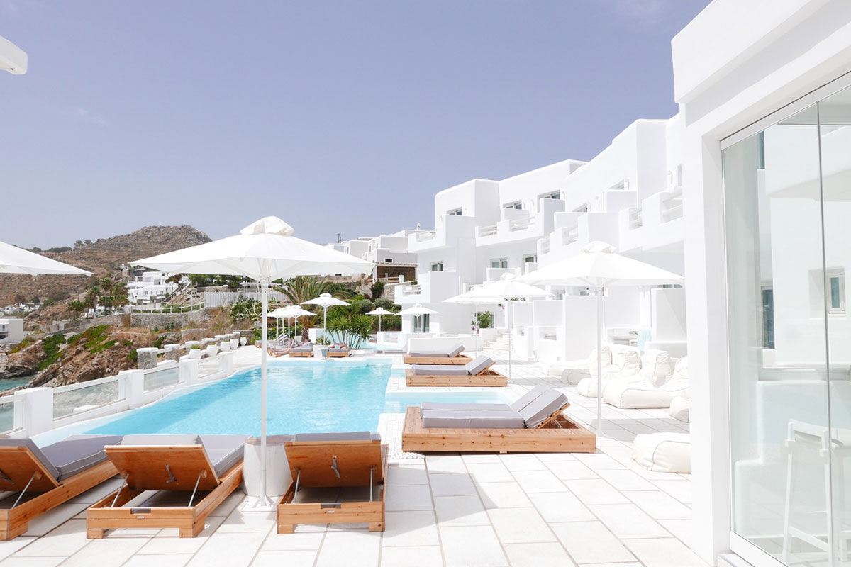 <b>Nissaki, Platis Yialos</b> - Surrounded by golden sunlight and clear blue waters, this luxury boutique hotel is set in traditional whitewashed buildings and features clean, streamline furnishings. Guests dine next to the Aegean Sea, swim in one of two pools with sun loungers nearby, and are only steps away from the renowned Platis Yialos Beach.