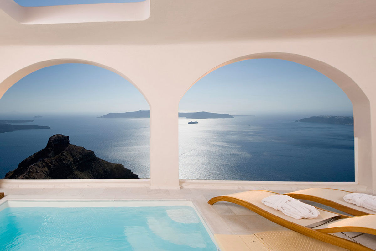 <b>Gold Suites, Imerovigli</b> - Located on the cliffside overlooking the Santorini Caldera, the Gold Suites offer spacious suites with a little glam. The infinity pool, poolside bar and open-air restaurant all face the Aegean Sea — and yet, you certainly will never tire of these views.
