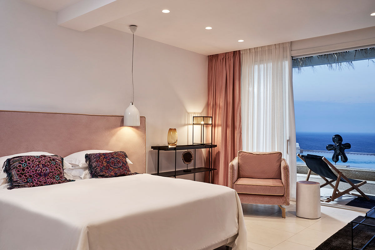 <b>Myconian Villa Collection, Elia</b> - Overlooking Elia Beach from its hillside perch, the Myconian Villa Collection offers luxurious rooms in a minimal Cycladic style with views of the Aegean Sea. Polished and contemporary, this hotel features an infinity pool, poolside bar and a fine dining restaurant right on the sundeck.