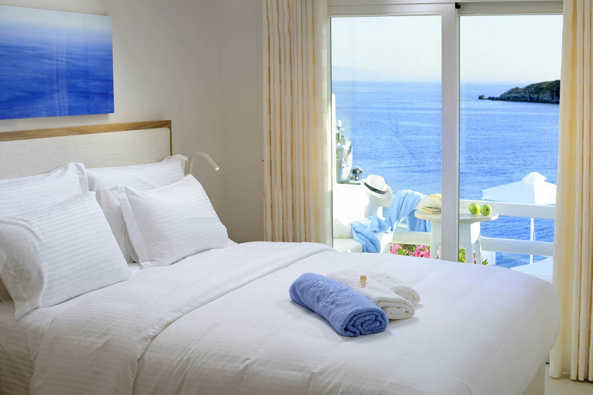 <b>Nissaki, Platis Yialos</b> - Surrounded by golden sunlight and clear blue waters, this luxury boutique hotel is set in traditional whitewashed buildings and features clean, streamline furnishings. Guests dine next to the Aegean Sea, swim in one of two pools with sun loungers nearby, and are only steps away from the renowned Platis Yialos Beach.