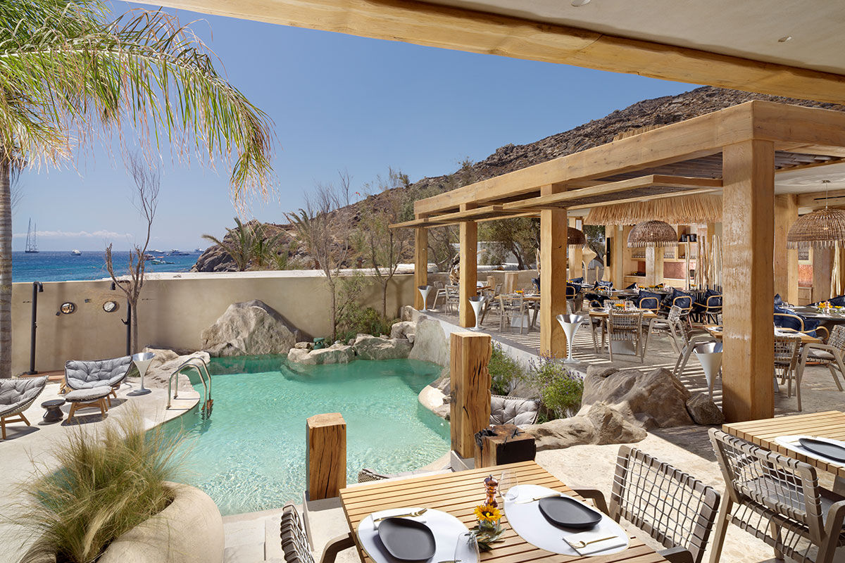 <b>Kensho, Psarou</b> - Nestled on Psarou Beach, Kensho is a clean, minimalist hotel with aged wood and stone trimmings. Rooms are contemporary and spacious, and guests can mingle at the poolside bar and restaurant with views of the crystal blue sea.