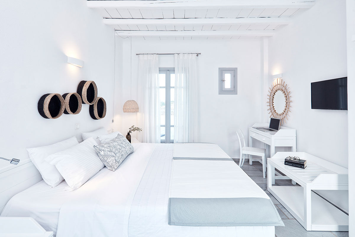 <b>Mr & Mrs White, Naoussa</b> - With clean lines, whitewashed stone, and contemporary boho details, Mr. & Mrs. White charms guests upon arrival. With two pools and only a stone’s throw away from Naoussa, laid back luxury is this boutique hotel’s specialty.