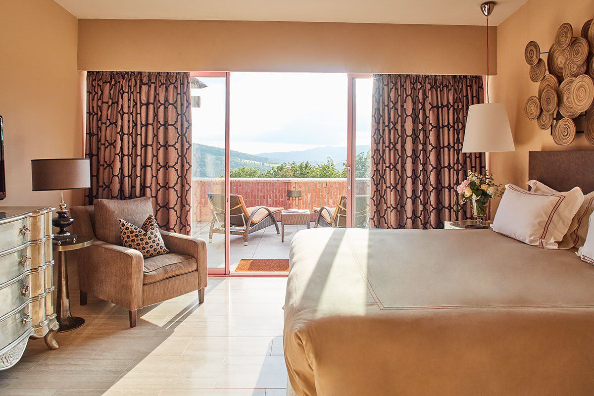 <b>Belmond Castello di Casole</b> - At this 10th century estate, wander the 4,200 acres of golden Tuscan countryside, relax in the wine cellar-turned-spacious spa or enjoy the valley-facing infinity pool. Surrounded by vineyards and olive groves, the Castello di Casole uses its panoramic views to inspire the rich traditional décor within.