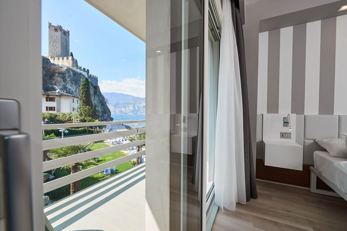 <b>Castello - Lake Front Hotel & Living Suites, Malcesine</b> - On the shores of Lake Garda, Hotel Castello is the perfect place to relax under a parasol on the private beach or dine on the lakefront terrace restaurant. It has an airy charm and is within walking distance of the historical alleyways downtown.