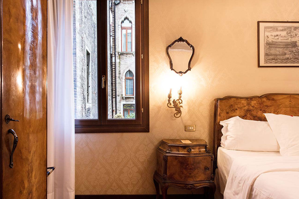 <b>Hotel Flora</b> - Covered in ivy and featuring traditional furnishings and chandeliers, Hotel Flora is a charming 17th century dream. Enjoy a peaceful breakfast in the leafy courtyard before heading to neighboring Saint Mark’s Square or Calle XXII Marzo for some upscale shopping.