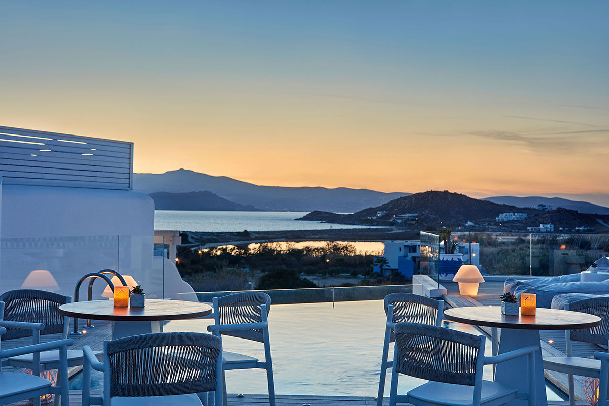 <b>18 Grapes, Agios Prokopios</b> – Within walking distance to Agios Prokopios beach, the 18 Grapes Hotel hints of Cycladic features amidst comfortable design. With a care-free island vibe, yet an attention to detail, this modern resort has everything you need: a two-level pool with lounge decks, sophisticated roof terrace, and the Grape Sunset bar restaurant.