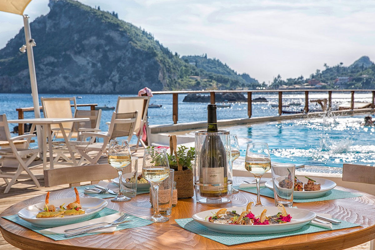 <b>Akrotiri Beach, Paleokastritsa</b> - Nestled into the cliff on the edge of the Alipa Marina, Akrotiri Beach Hotel hums with activity: guests relax at the sun terrace bar, swim in the infinity pool and pack their bathing suits for a trip to Agia Triada Beach.