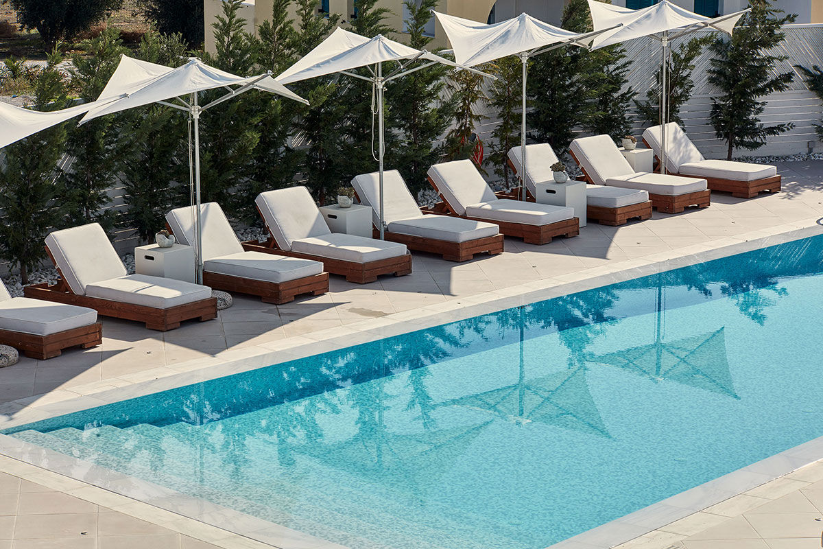 <b>18 Grapes, Agios Prokopios</b> – Within walking distance to Agios Prokopios beach, the 18 Grapes Hotel hints of Cycladic features amidst comfortable design. With a care-free island vibe, yet an attention to detail, this modern resort has everything you need: a two-level pool with lounge decks, sophisticated roof terrace, and the Grape Sunset bar restaurant.