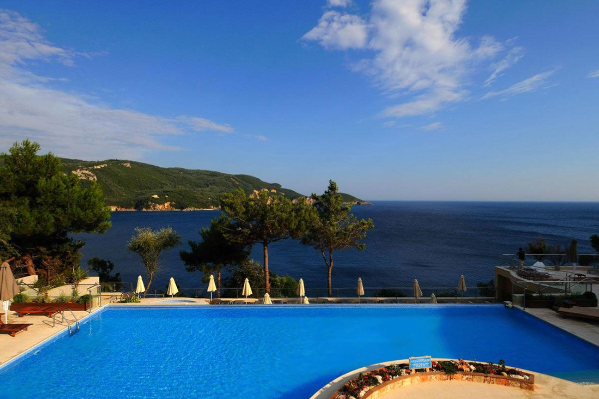 <b>Akrotiri Beach, Paleokastritsa</b> - Nestled into the cliff on the edge of the Alipa Marina, Akrotiri Beach Hotel hums with activity: guests relax at the sun terrace bar, swim in the infinity pool and pack their bathing suits for a trip to Agia Triada Beach.