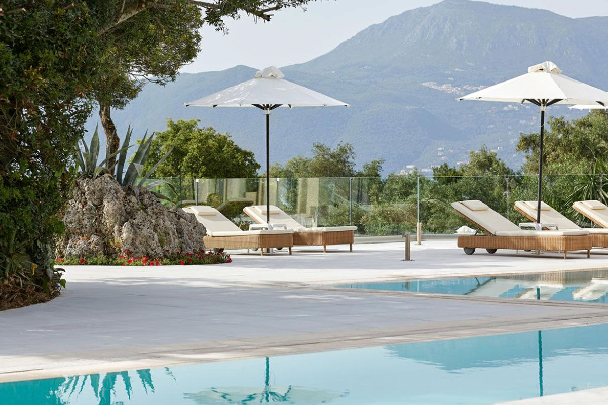 <b>Grecotel Eva Palace, Kommeno</b> - With a private beach and sweeping views of the Ionian Sea and Corfu Town, the Grecotel Eva Palace is a prime location for guests wanting luxury and glam. The rooms are bright, cheery and have an enchanting beach feel.