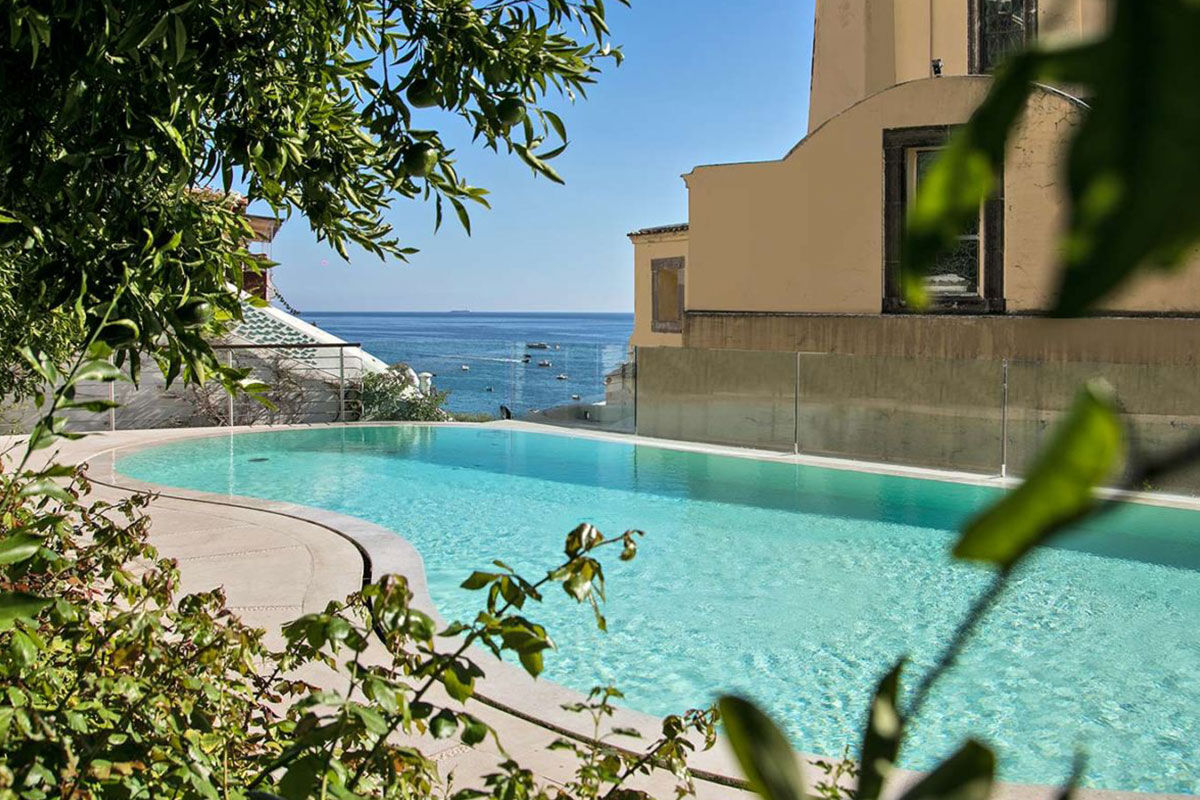 <b>Palazzo Murat, Positano</b> - A patrician residence with a secret garden to explore, this 18th century palazzo serves as an oasis right in the center of Positano. Palazzo Murat has a certain glamorous charm with its shaded terraces, canvas parasols, and sun loungers by the pool.