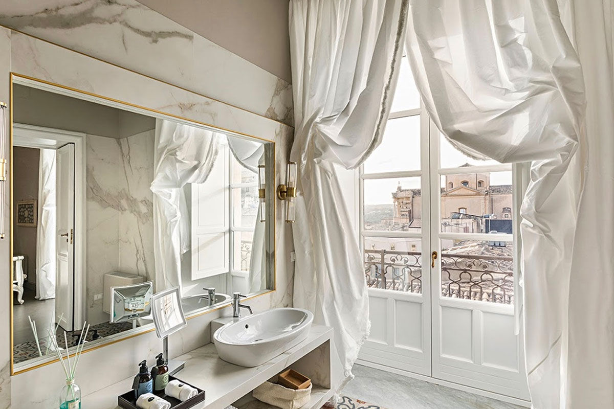 <b>Seven Rooms Villadorata, Noto</b> - Having once been home to a prince, there’s a stately air to Seven Rooms Villadorata with its floor to ceiling windows, gilded tiles and frescoed ceilings. The cocktail bar is swanky, the restaurant has vaulted ceilings and fine fabrics are used throughout the property for an especially luxurious palette.