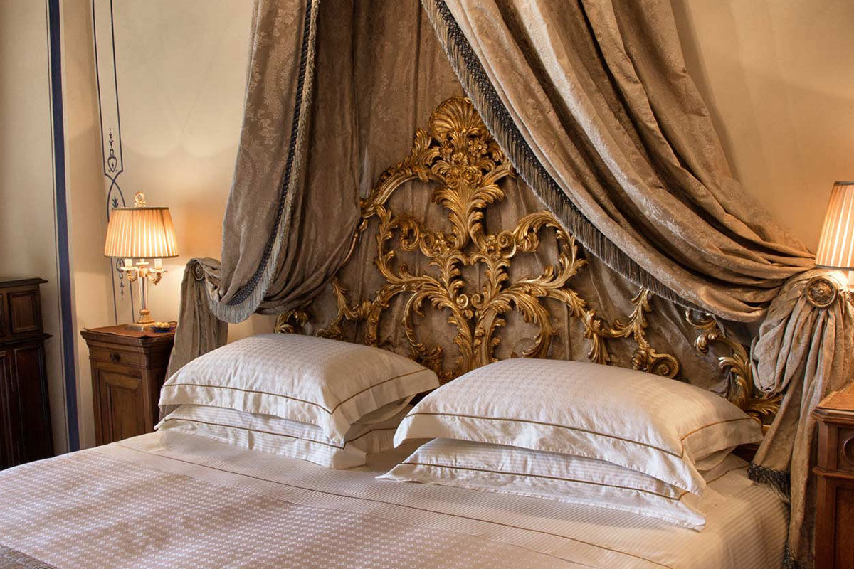 <b>Relais & Chateaux Castello di Guarene</b> - Set on a hill overlooking the lush landscape, this 18th century palace is striking in appearance. With a stately garden and an underground cave pool to enjoy, guests feel the grandeur and splendor of Old-World luxury.