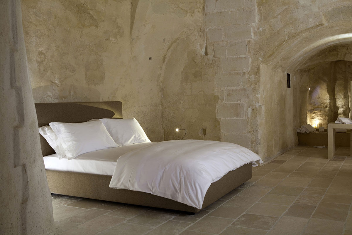 <b>Corte San Pietro, Matera</b> - Cave dwellings, tufa stone courtyards and herb gardens are all things you’ll find when arriving at the Corte San Pietro. Quite like a dream, you will sleep in a plush cave room with a design worthy of an architectural magazine.