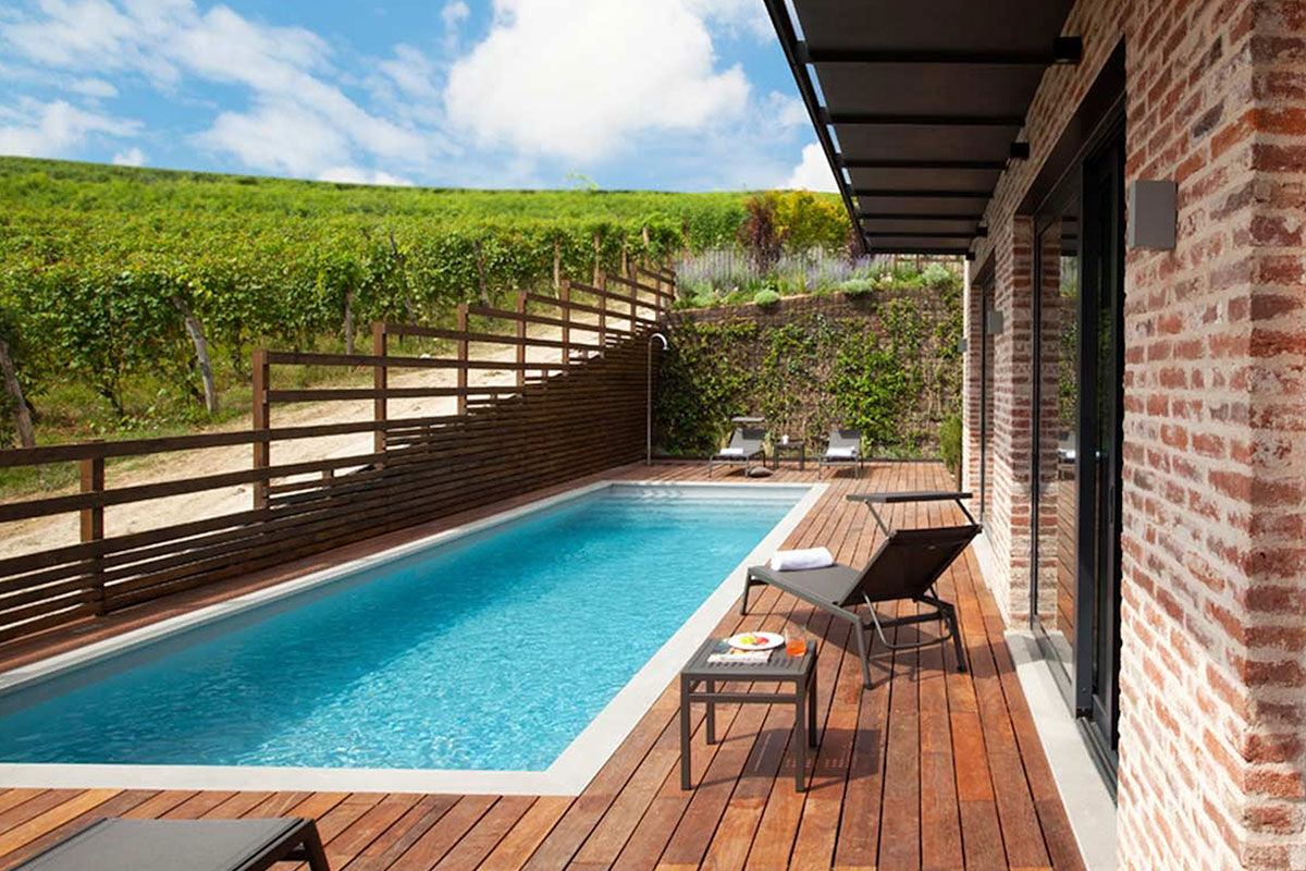 <b>Arborina Relais</b> - Surrounded by Barolo hill vineyards and sitting atop lush grounds, the Arborina Relais is a modern boutique hotel that offers luxury and style. The architectural lines, large windows and natural materials make it an experience hand in hand with nature.