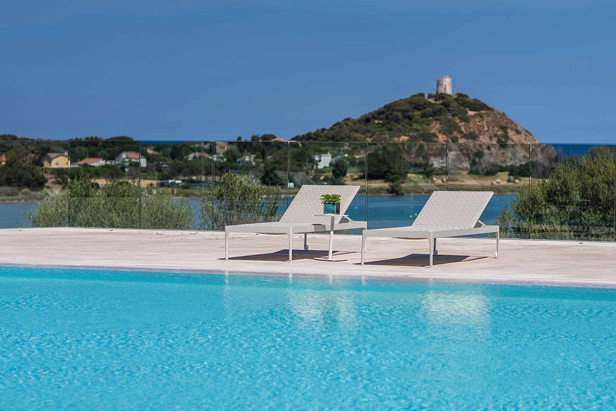 <b>Chia Laguna</b> - Located in the southern Cagliari province, the Chia Laguna consists of 3 hotels — all of which are a testament to Italian hospitality. With untouched natural beauty, this resort offers unadulterated views of the ocean and lagoon (which is home to pink flamingos)!