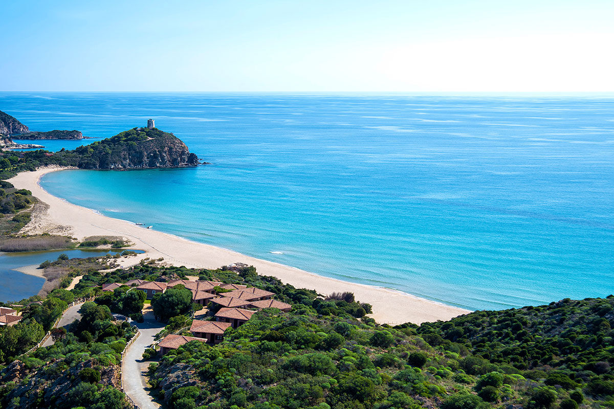 <b>Chia Laguna</b> - Located in the southern Cagliari province, the Chia Laguna consists of 3 hotels — all of which are a testament to Italian hospitality. With untouched natural beauty, this resort offers unadulterated views of the ocean and lagoon (which is home to pink flamingos)!