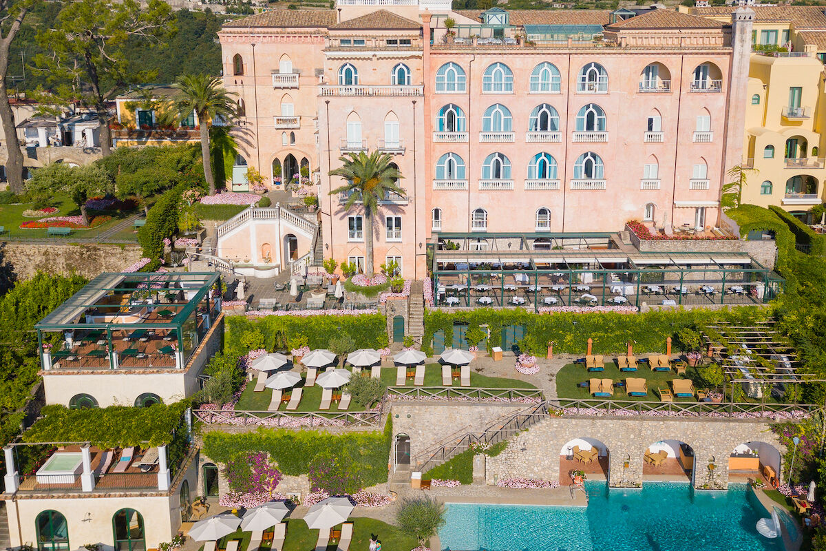 <b>Palazzo Avino, Ravello</b> - Named the ‘Pink Palace’ by locals, the Palazzo Avino has been charming cosmopolitan travelers with its blush walls and terraced coastal gardens since the 12th century. With its Michelin-starred restaurant and terrace with views over the Tyrrhenian Sea, this luxury hotel holds on to its romantic glamor of old while bringing the contemporary plush of new.