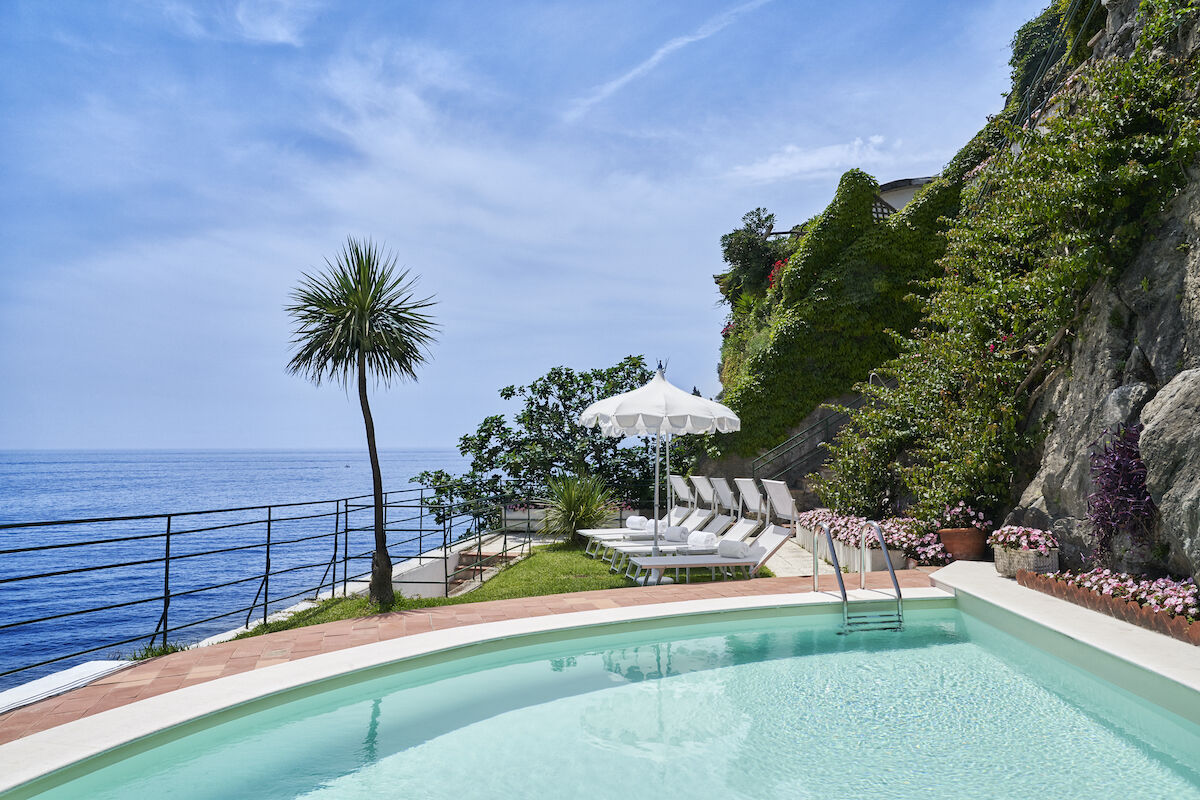 <b>Palazzo Avino, Ravello</b> - Named the ‘Pink Palace’ by locals, the Palazzo Avino has been charming cosmopolitan travelers with its blush walls and terraced coastal gardens since the 12th century. With its Michelin-starred restaurant and terrace with views over the Tyrrhenian Sea, this luxury hotel holds on to its romantic glamor of old while bringing the contemporary plush of new.