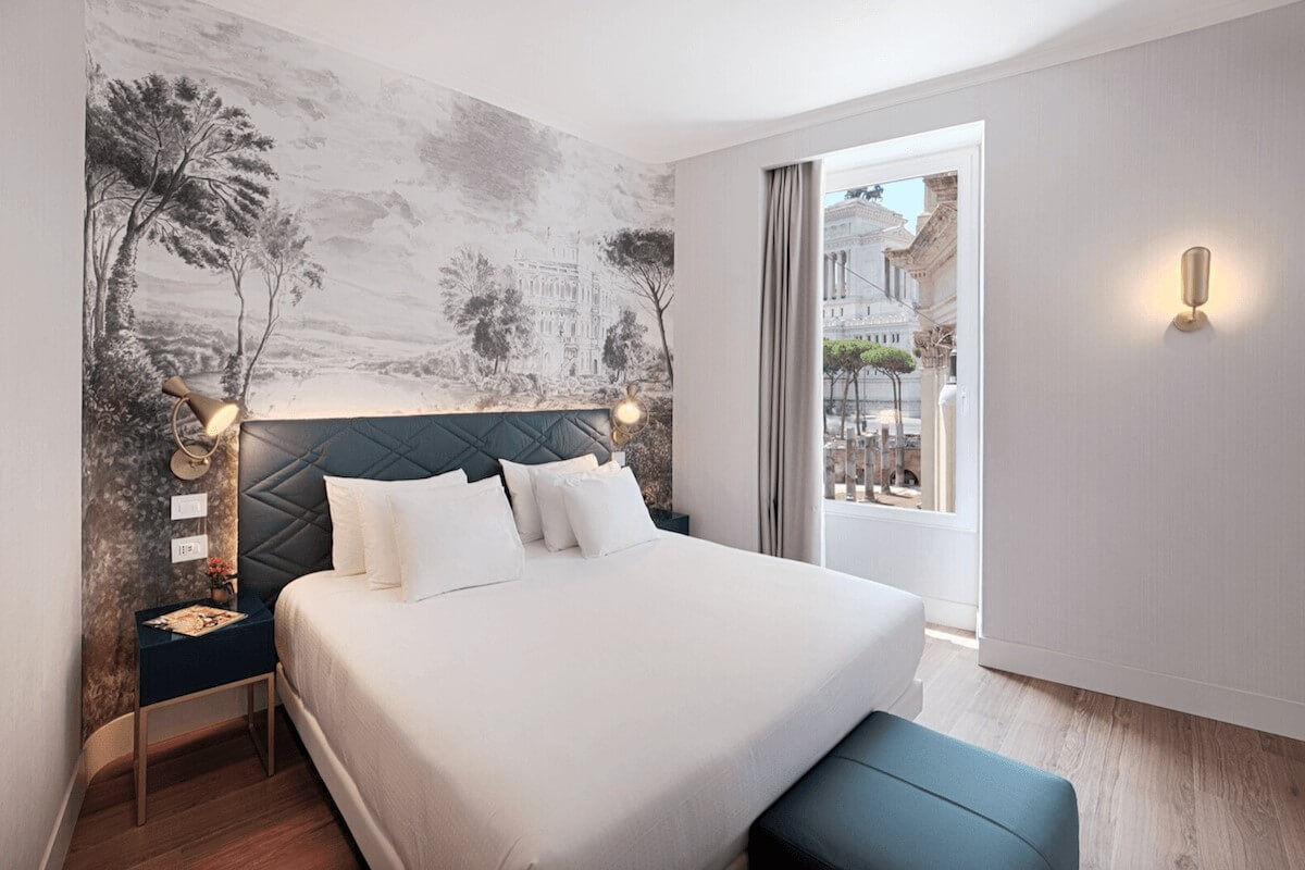 <b>NH Collection Roma Fori Imperiali</b> - Set overlooking the Roman Forum, this boutique hotel is home to a panoramic cocktail lounge, bistro, and two bars. With light and airy rooms, sweet dragonfly wallpaper and checkered marble floors, this charming hotel is a calming retreat after a day of exploring.