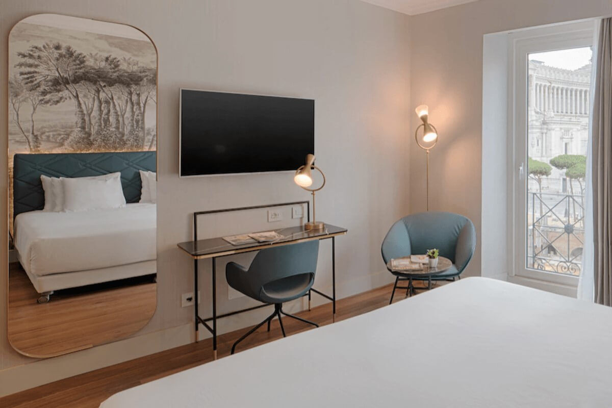 <b>NH Collection Roma Fori Imperiali</b> - Set overlooking the Roman Forum, this boutique hotel is home to a panoramic cocktail lounge, bistro, and two bars. With light and airy rooms, sweet dragonfly wallpaper and checkered marble floors, this charming hotel is a calming retreat after a day of exploring.